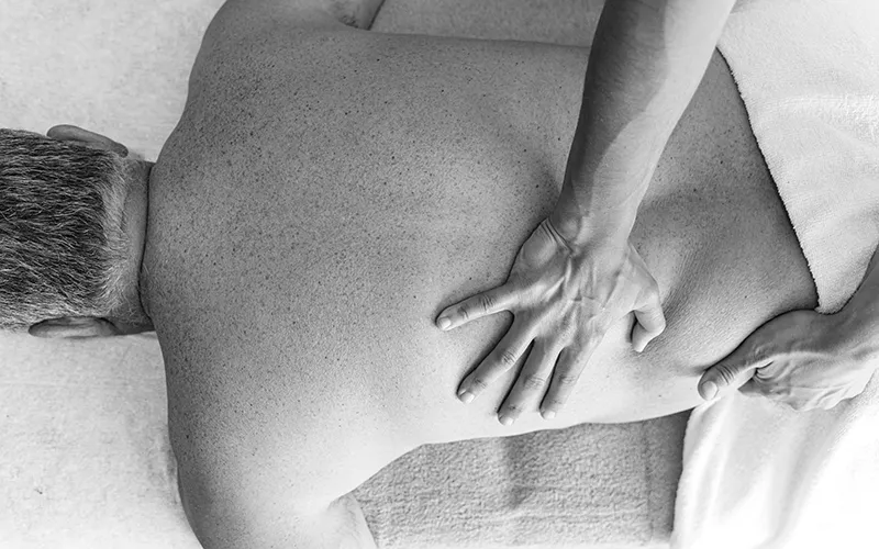 WIN_25_ClinicalExplorations_Secondary2_Stocksy_3199129_800 A prone client has his back and side worked on by a massage therapist.