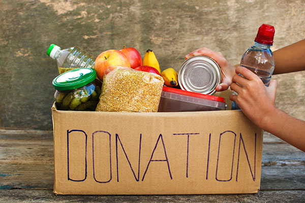 A box of canned goods and food marked "Donations" 