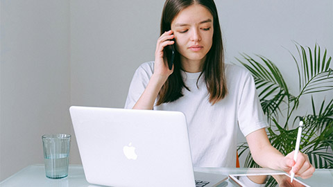 Image of a person working on their laptop.