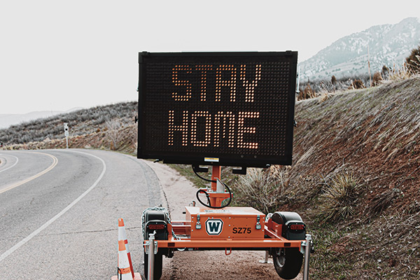 Construction traffic sign displaying "Stay Home"