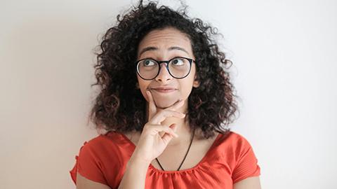 Image of a person with their hand to their chin, deep in thought.