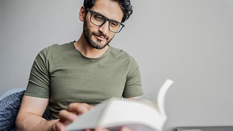 Image of a person reading a book.