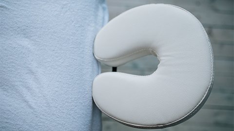 A top down image of a massage table and the face cradle.