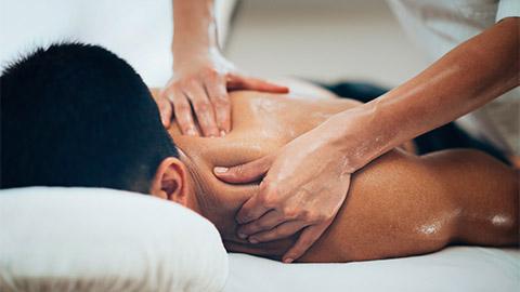 Image of a person receiving massage to their shoulder.